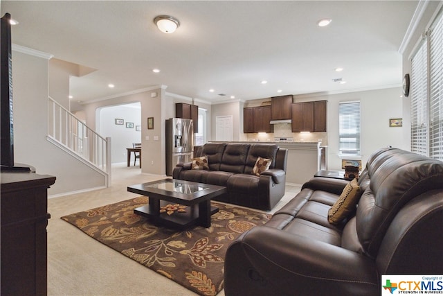 carpeted living room with ornamental molding