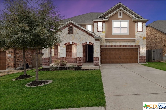 view of front of home with a garage and a yard