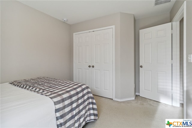 carpeted bedroom with a closet