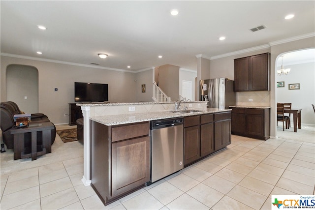 kitchen featuring sink, dark brown cabinets, crown molding, and stainless steel appliances