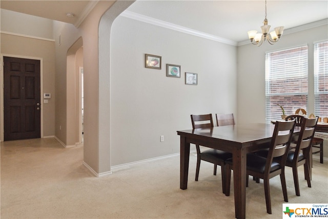 carpeted dining space with an inviting chandelier and ornamental molding