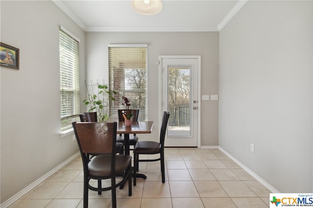 dining area with light tile patterned floors and crown molding