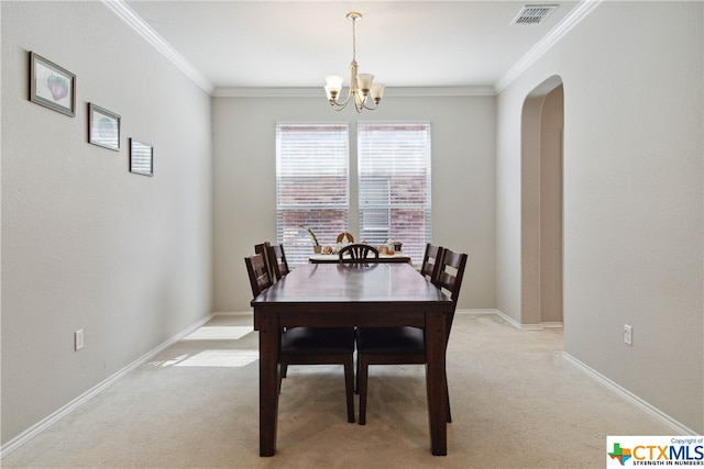 dining space with light carpet, ornamental molding, and a notable chandelier