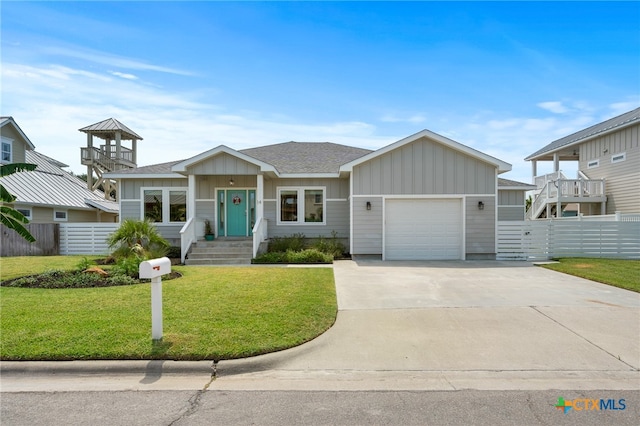 view of front of home featuring a garage and a front yard