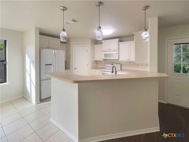 kitchen featuring white cabinetry, kitchen peninsula, hanging light fixtures, and white appliances