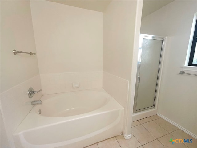 bathroom with tile patterned floors and plus walk in shower