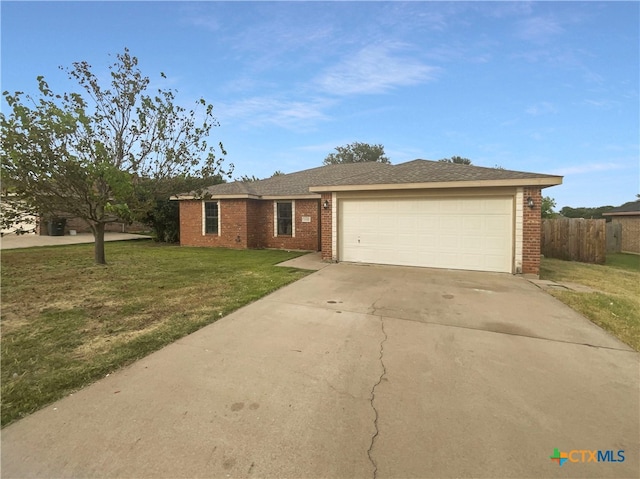 single story home featuring a garage and a front lawn