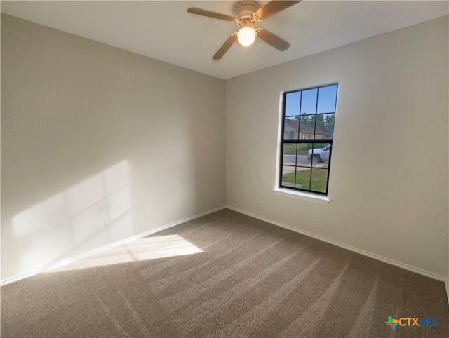 carpeted spare room featuring ceiling fan