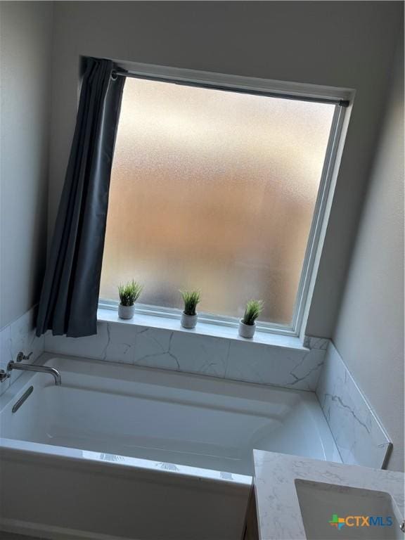 bathroom featuring a garden tub