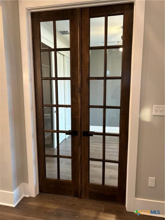 doorway to outside featuring visible vents, french doors, baseboards, and dark wood-style floors
