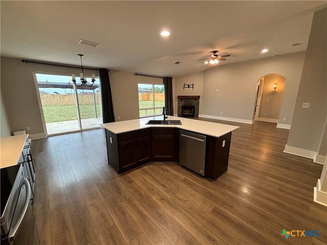 kitchen featuring light countertops, dishwasher, visible vents, a fireplace, and open floor plan
