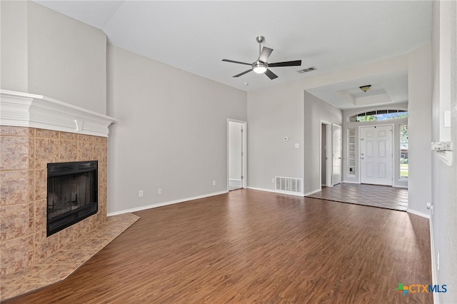 7915 Redbrush, Temple, TX 76502 - unfurnished living room featuring wood finished floors, a ceiling fan, and a tiled fireplace