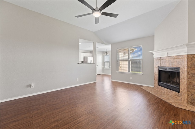 7915 Redbrush, Temple, TX 76502 - unfurnished living room featuring a tile fireplace, dark wood-style floors, lofted ceiling, and ceiling fan