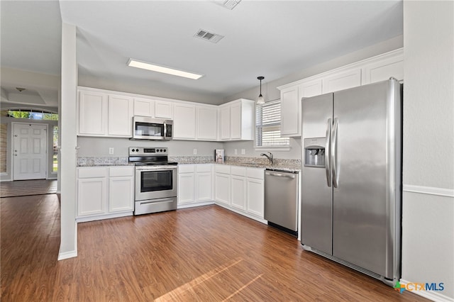 7915 Redbrush, Temple, TX 76502 - kitchen with stainless steel appliances, white cabinets, wood finished floors, and light stone countertops