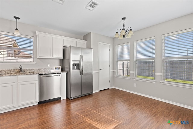 7915 Redbrush, Temple, TX 76502 - kitchen with stainless steel appliances, a chandelier, dark wood-style floors, and white cabinetry