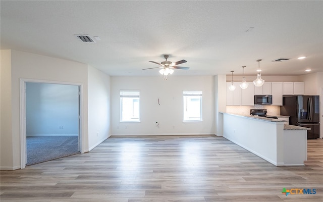 kitchen featuring black appliances, ceiling fan, white cabinetry, light wood-type flooring, and decorative light fixtures