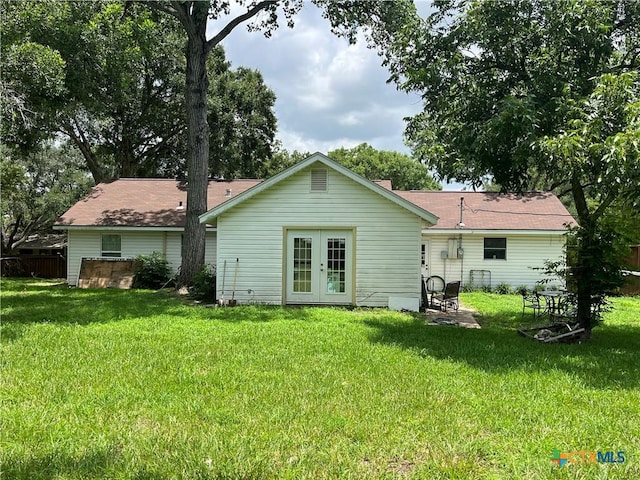 306 Angus St, Victoria, TX 77904 - back of house featuring french doors, a lawn, and a patio