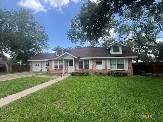 306 Angus St, Victoria, TX 77904 - view of front of home featuring brick siding, driveway, and a garage