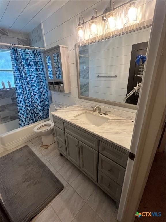 306 Angus St, Victoria, TX 77904 - bathroom featuring vanity and shower / bathtub combination with curtain