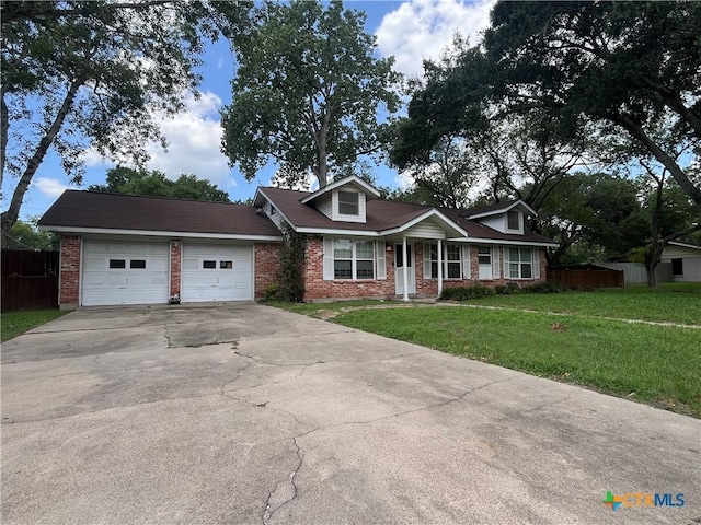 306 Angus St, Victoria, TX 77904 - view of front of home with brick siding, driveway, and a garage