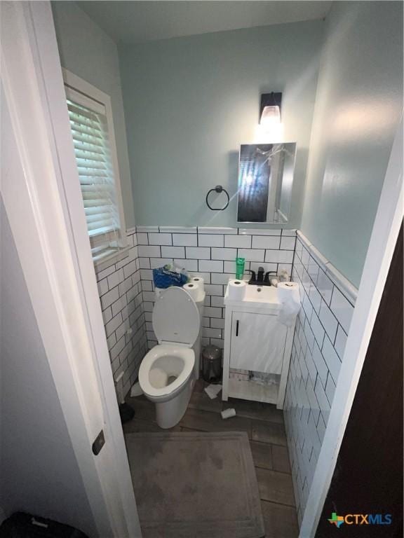 306 Angus St, Victoria, TX 77904 - half bath with tile walls, vanity, and wainscoting