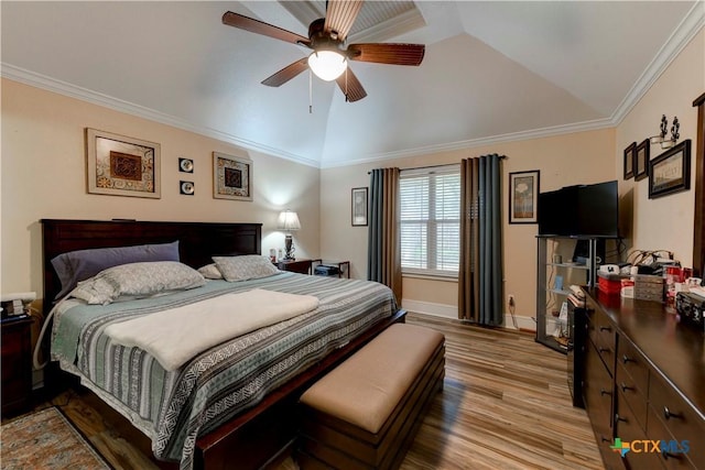 bedroom with ceiling fan, crown molding, vaulted ceiling, wood finished floors, and baseboards