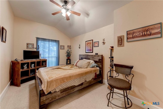 bedroom featuring baseboards, lofted ceiling, and light colored carpet
