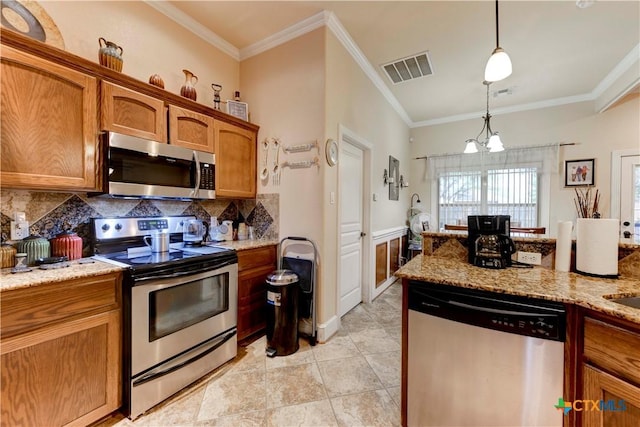 kitchen with appliances with stainless steel finishes, brown cabinetry, decorative backsplash, visible vents, and ornamental molding