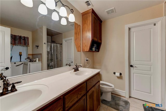bathroom featuring toilet, visible vents, and a sink