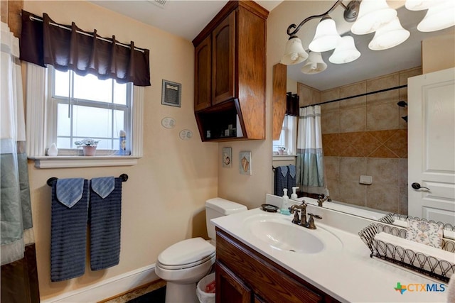 bathroom featuring vanity, toilet, a chandelier, a shower with shower curtain, and baseboards