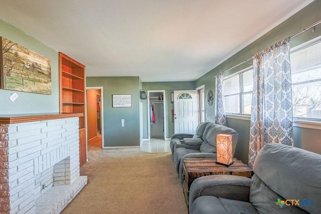 carpeted living room with built in shelves and a brick fireplace