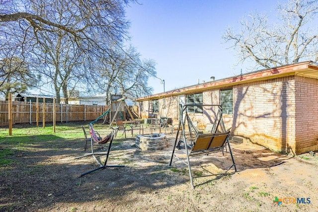 view of jungle gym featuring a fire pit