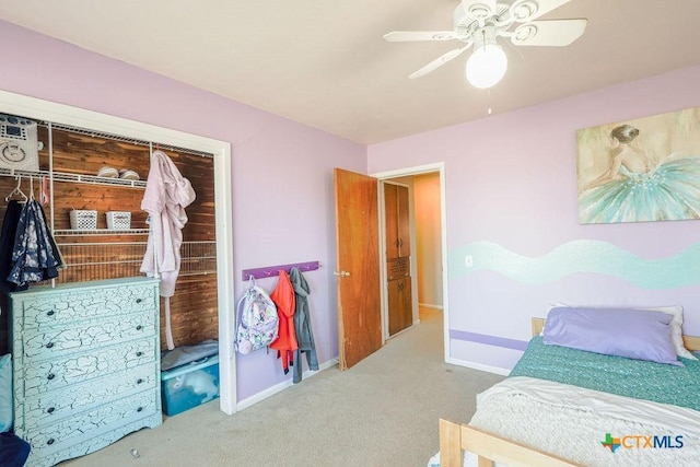 carpeted bedroom with ceiling fan and a closet