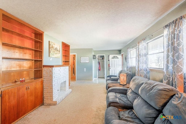 living room featuring light colored carpet, a textured ceiling, and a brick fireplace