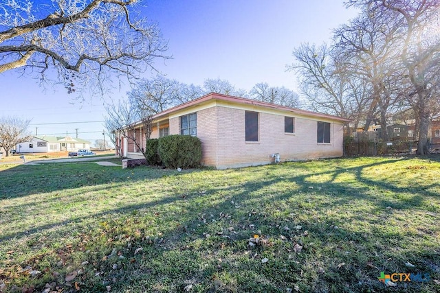 view of side of property featuring a yard