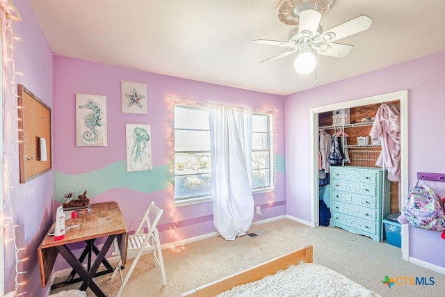 carpeted bedroom featuring a closet and ceiling fan