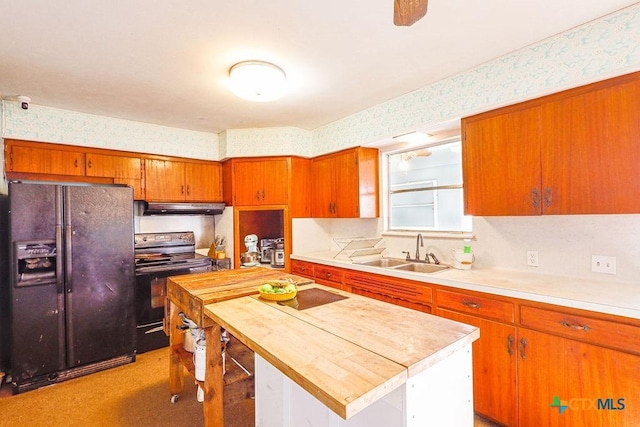 kitchen with a center island, black appliances, and sink