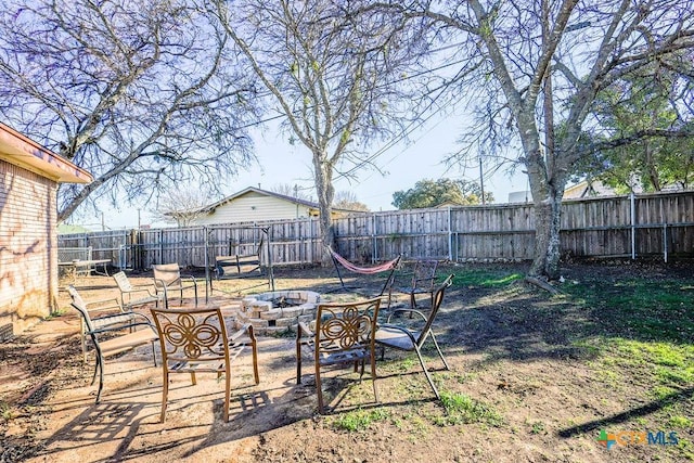 view of yard with a fire pit