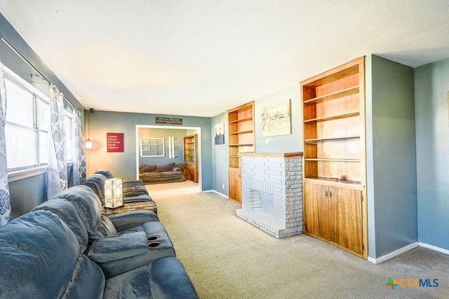 carpeted living room featuring a fireplace and built in features