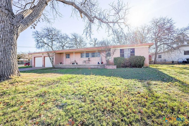 single story home with a garage and a front lawn