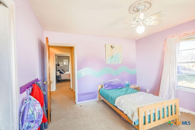 bedroom with light colored carpet and ceiling fan