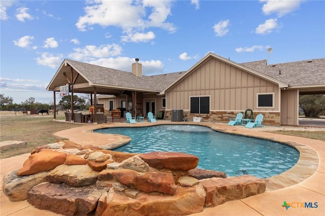 outdoor pool with central air condition unit and a patio