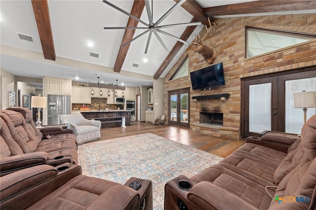 living room with wood finished floors, french doors, and visible vents