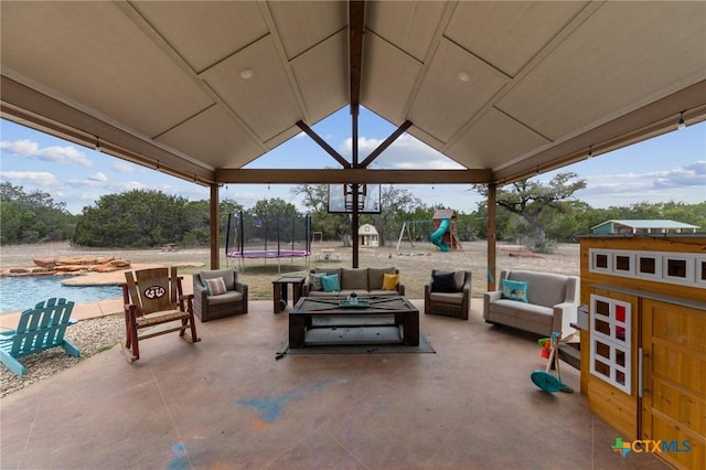 view of patio / terrace with outdoor lounge area, a playground, a trampoline, and an outdoor pool