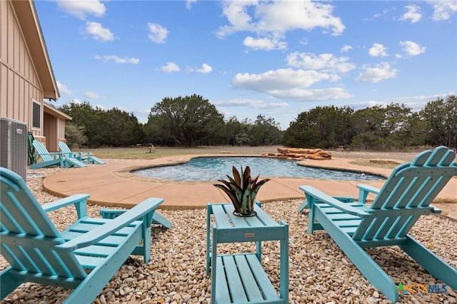 view of swimming pool with a swimming pool, a patio, and central air condition unit