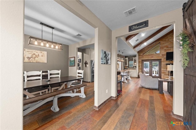 interior space featuring visible vents, beamed ceiling, and wood-type flooring