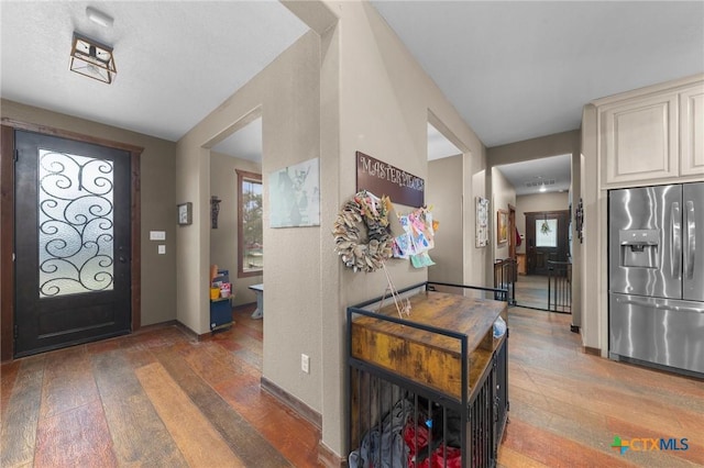 entrance foyer featuring baseboards and wood-type flooring