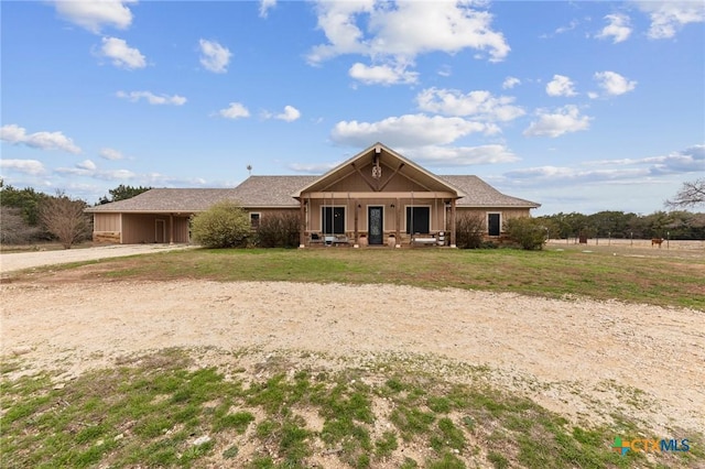 craftsman-style home with a front yard and driveway