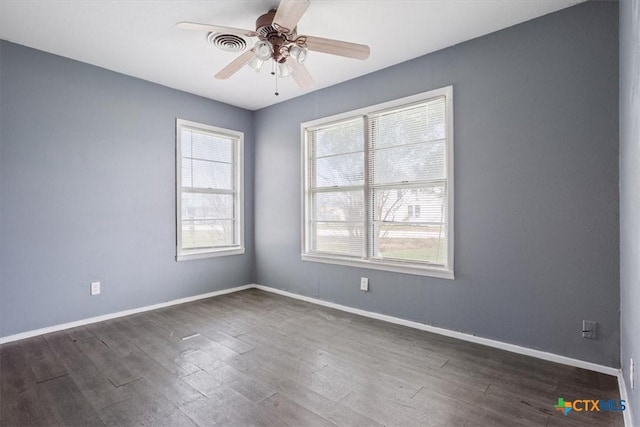 unfurnished room featuring ceiling fan, plenty of natural light, and dark hardwood / wood-style floors