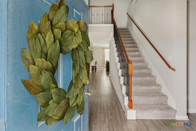 stairway featuring hardwood / wood-style flooring